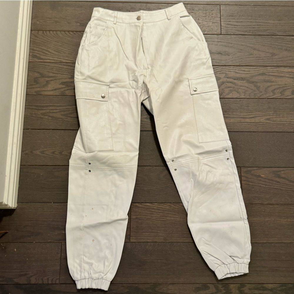 White leather cargo pants cinched at ankles